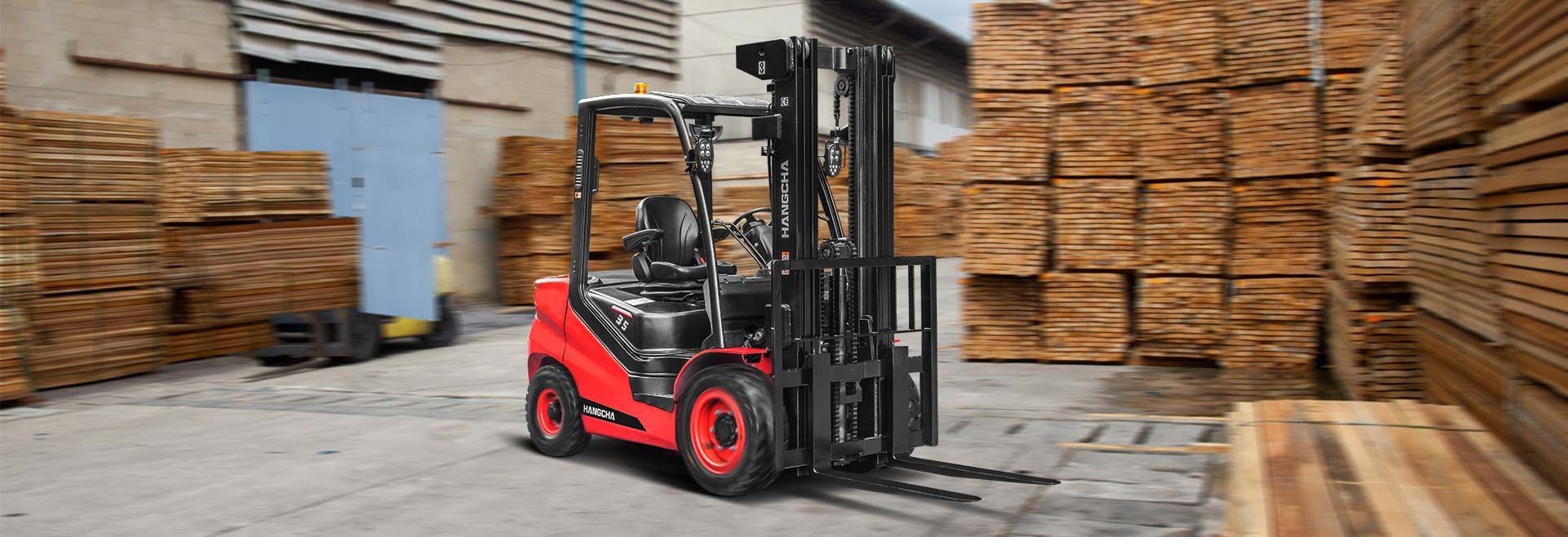 A Red Forklift Is Parked In Front Of A Pile Of Wood — Lift It Equipment in Summerland Point, NSW