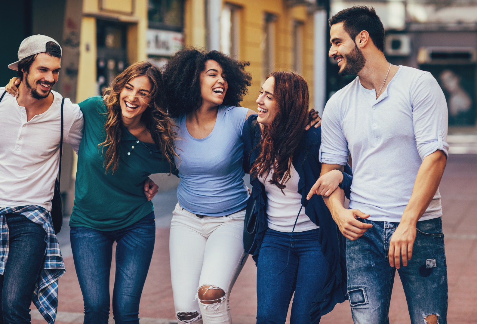 A group of young people are walking down the street.
