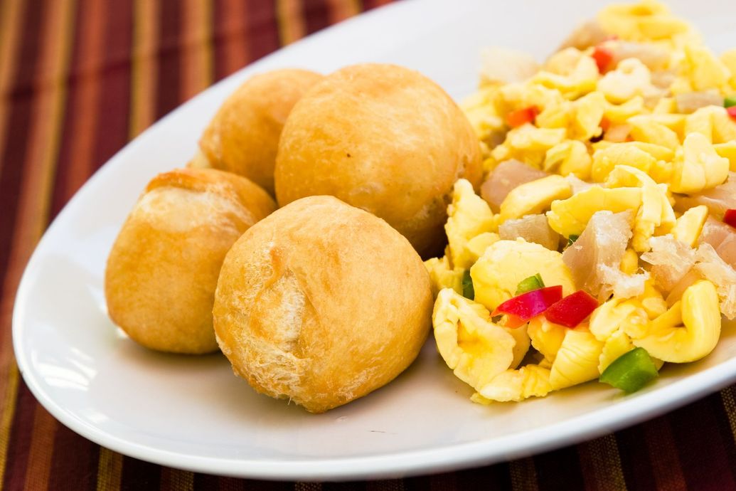 A plate of food with eggs and bread on a table.
