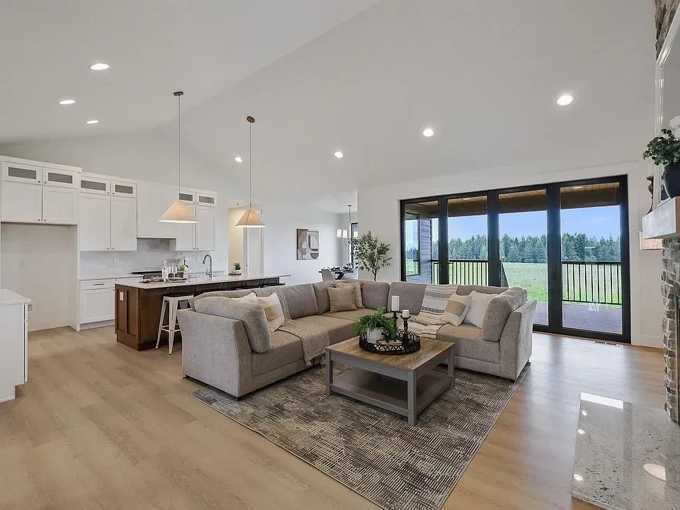 A living room with a large sectional couch and a coffee table.