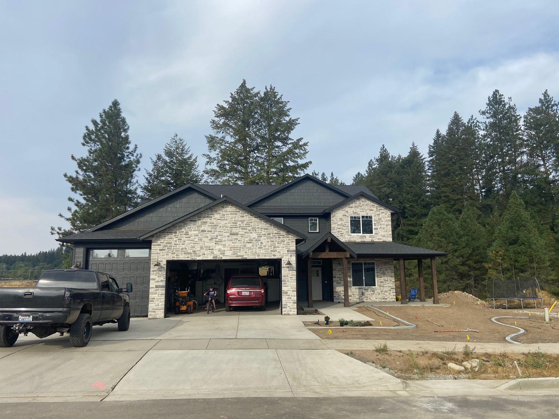 A truck is parked in front of a large house.