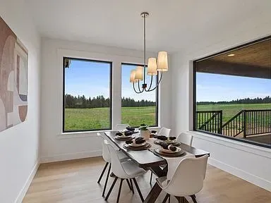A dining room with a table and chairs and a chandelier.