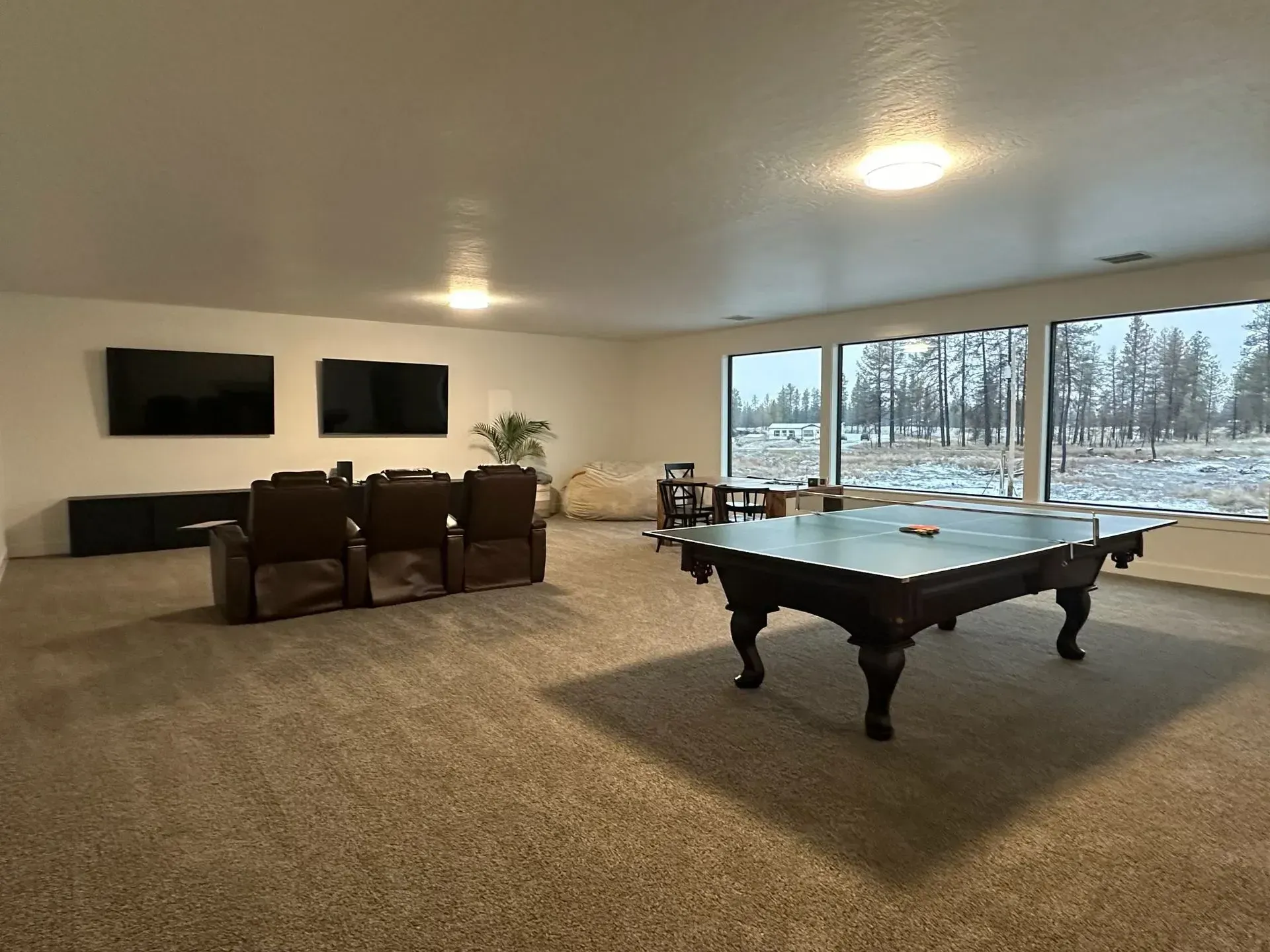 There is a pool table in the middle of the room.