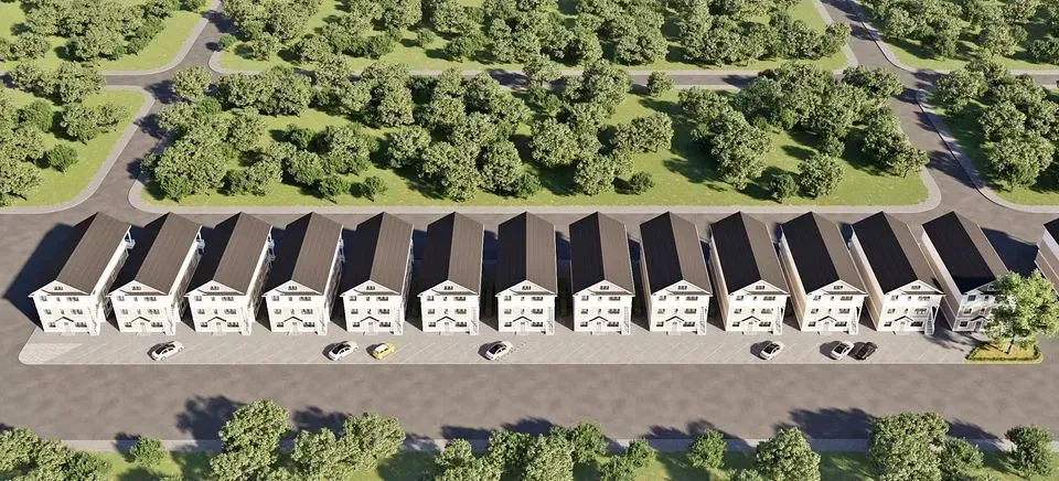 An aerial view of a row of houses surrounded by trees