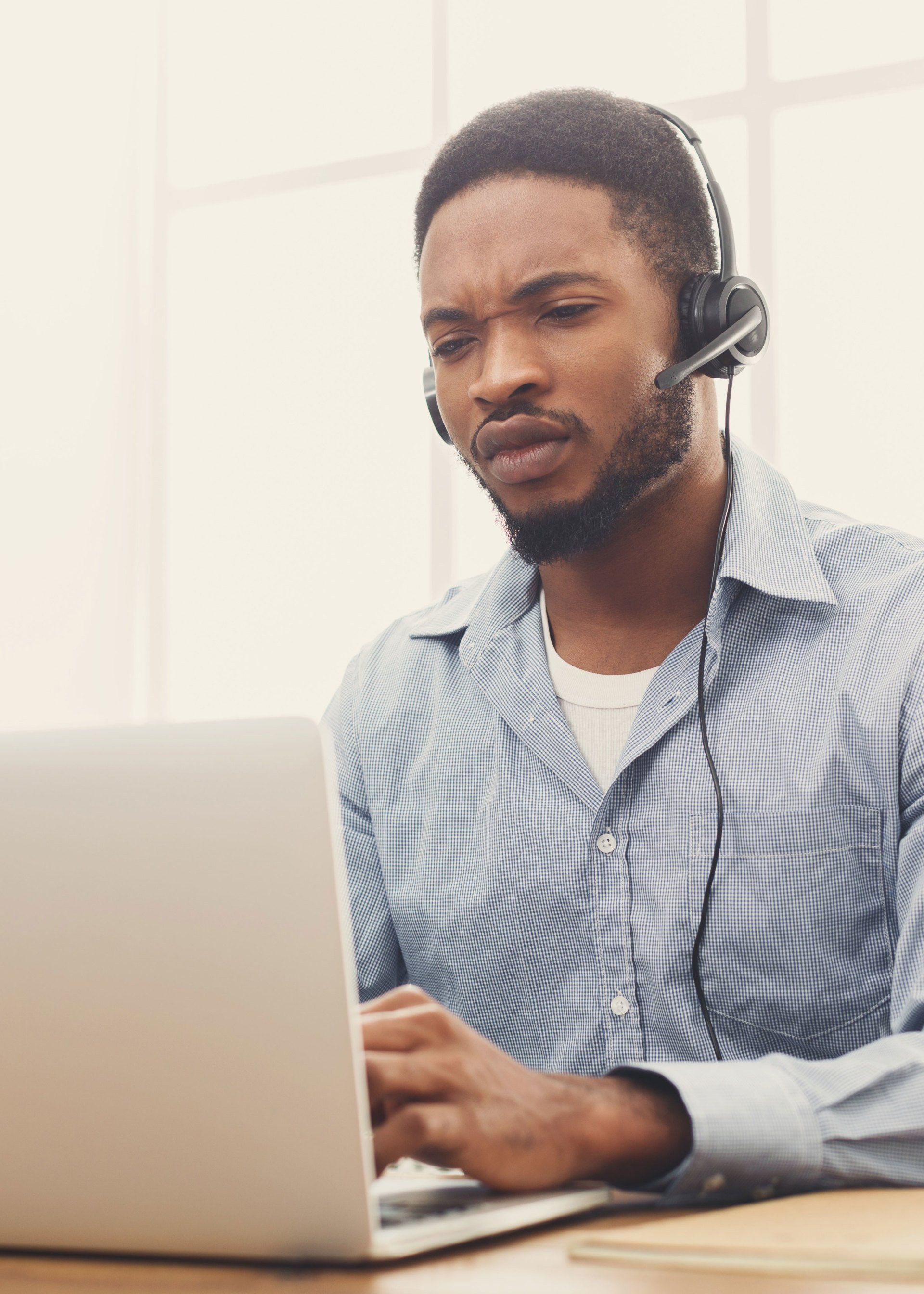 Man learning online with headset.
