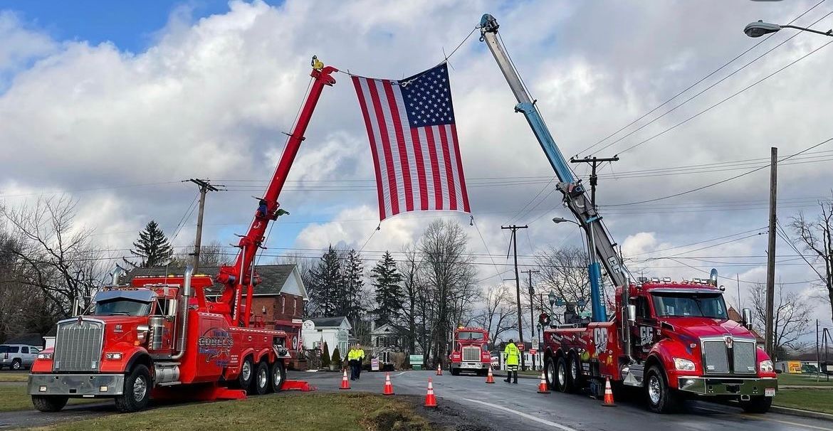 fourth of july parade with american flag with towing company