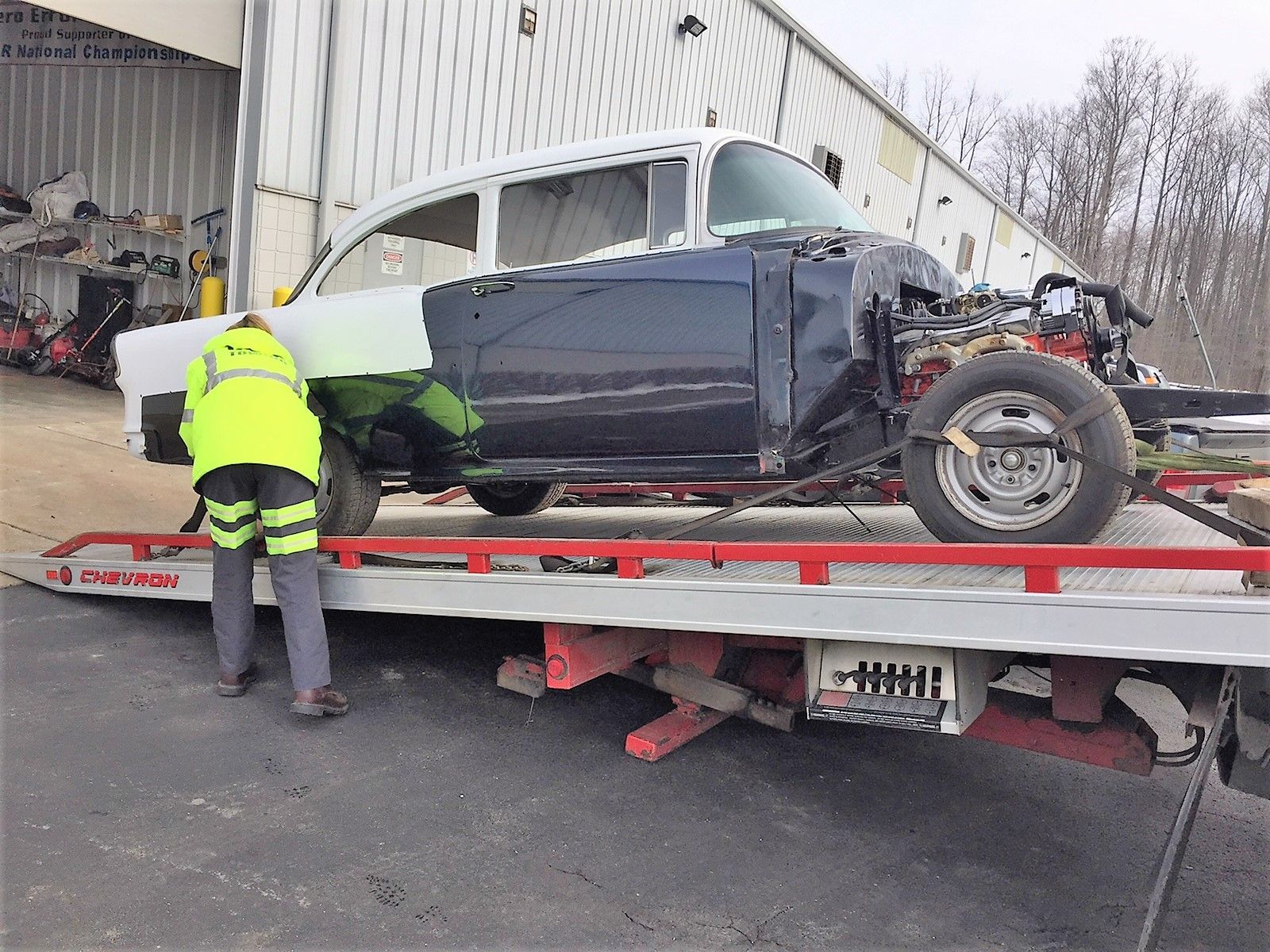 small car loaded onto back of towing truck