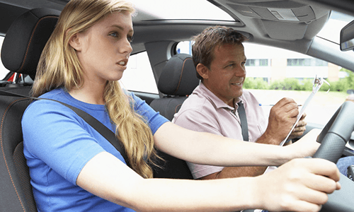 Instructor helping a woman drive