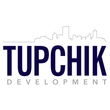 Logo for Tupchik Development with a cityscape outline above dark blue text.