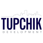Logo for Tupchik Development with a cityscape outline above dark blue text.