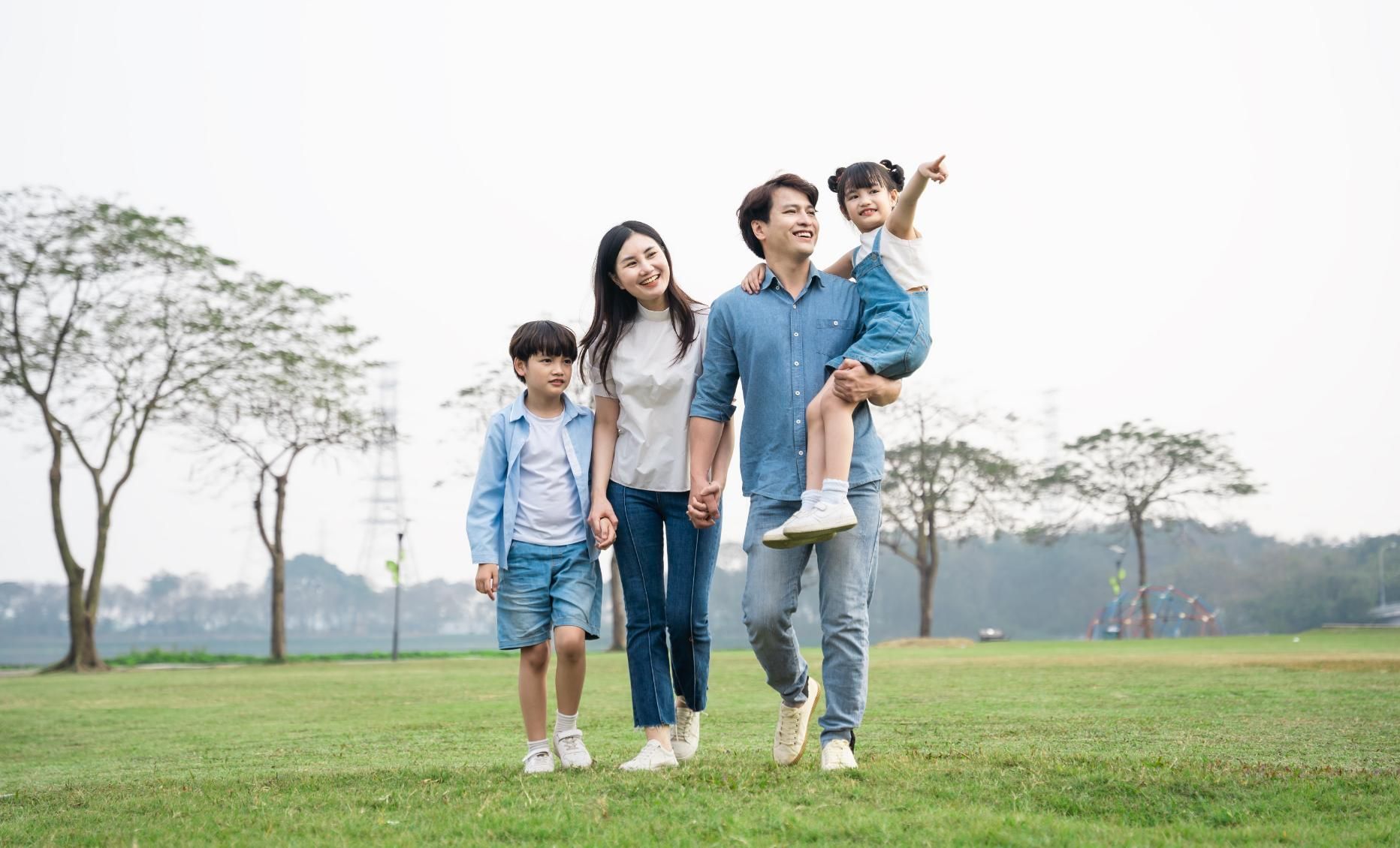 A family is walking in a park together.