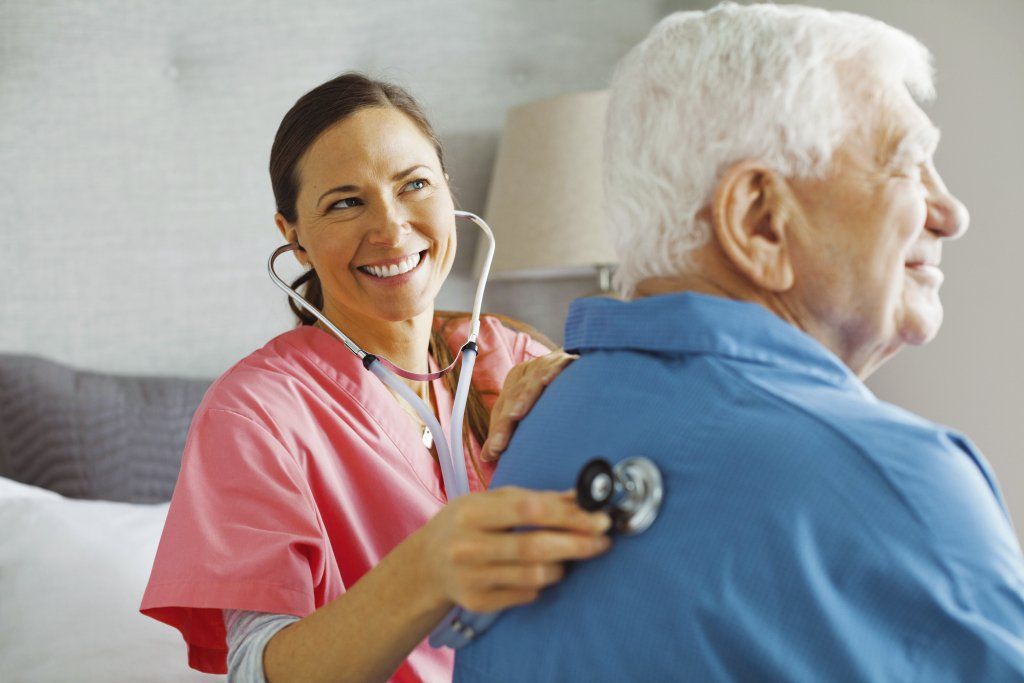 A female nurse listened to the heartbeat of an elderly man using a stethoscope.