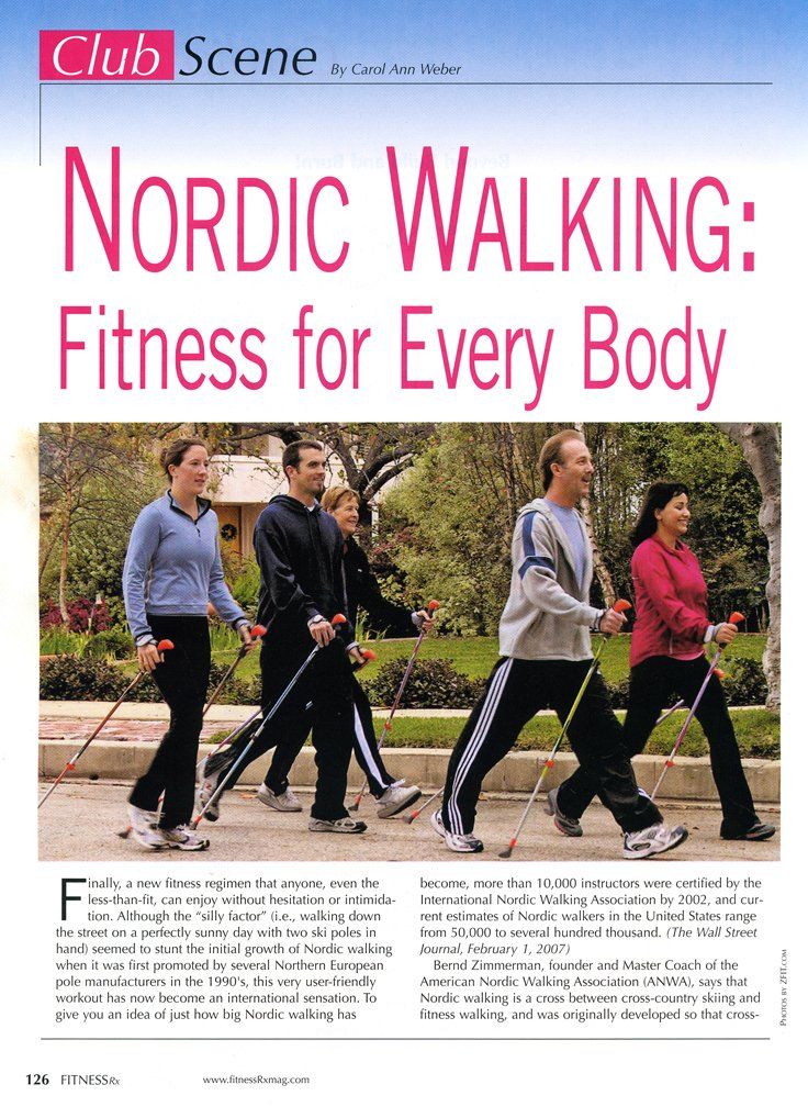 A group of people are walking down a street with nordic walking poles.