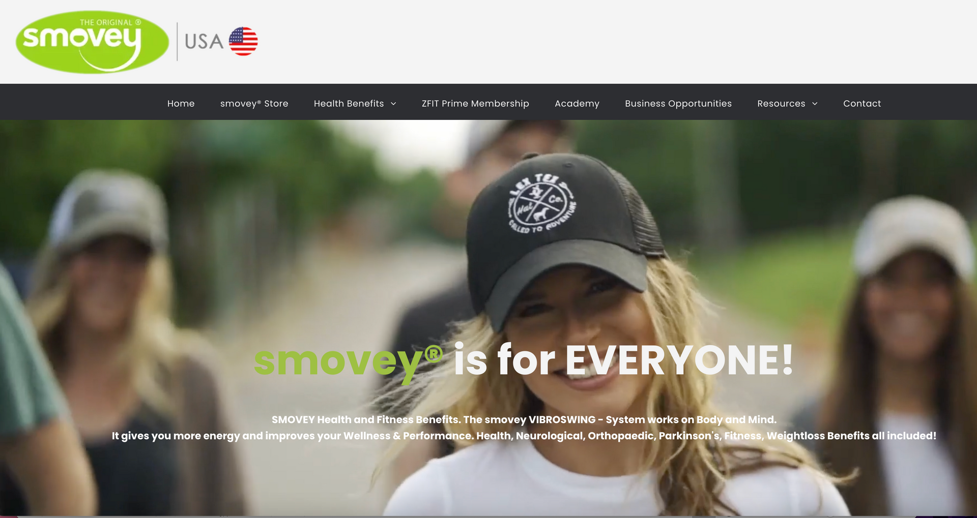 A woman wearing a hat is standing in front of a group of people.