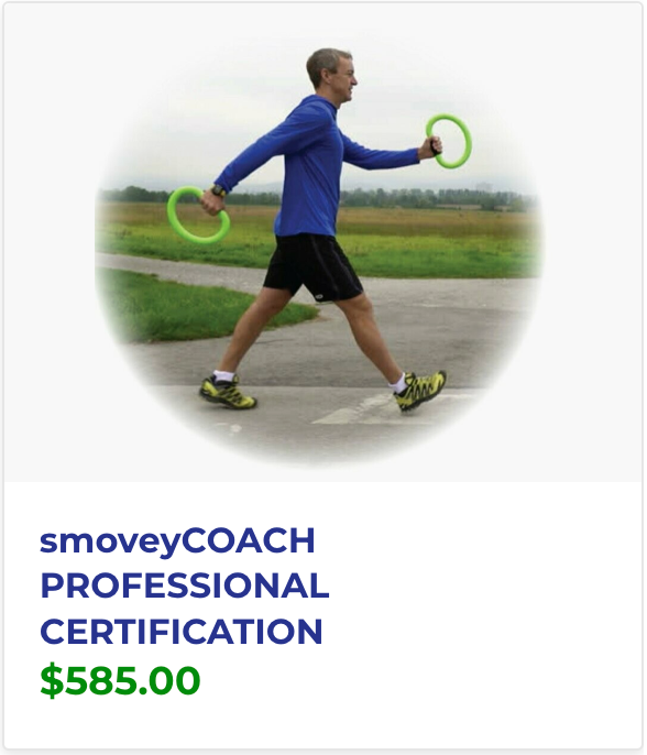 A man in a blue shirt is walking with two green rings in his hands