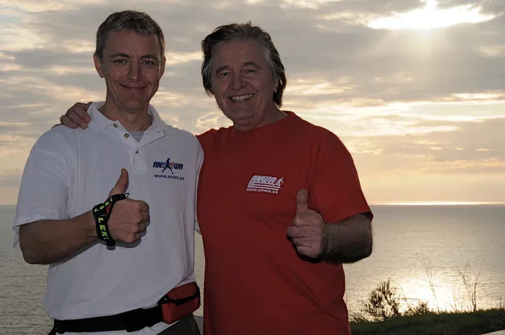 A group of people posing for a picture with walking poles