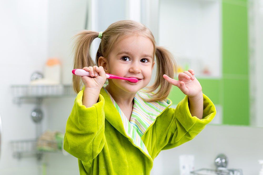 happy girl brushing her teeth