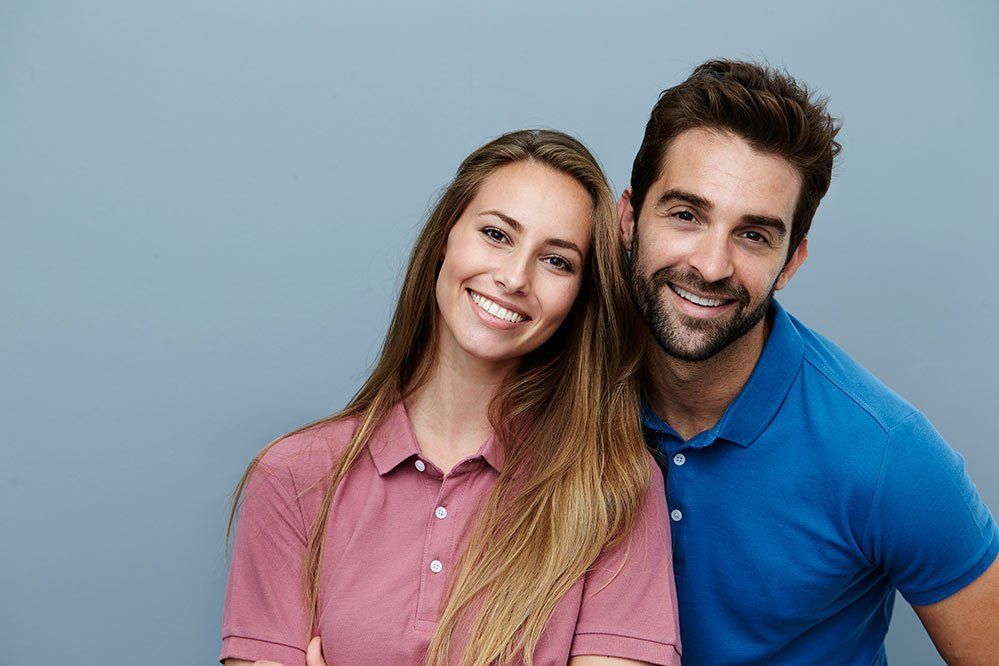 man and woman smiling together
