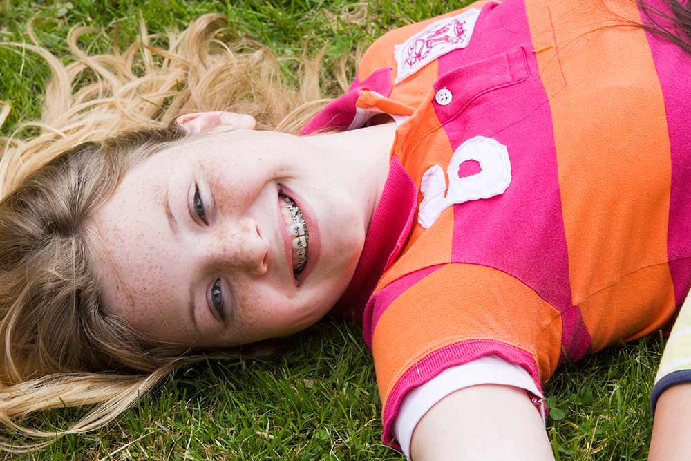 young girl smiling on grass