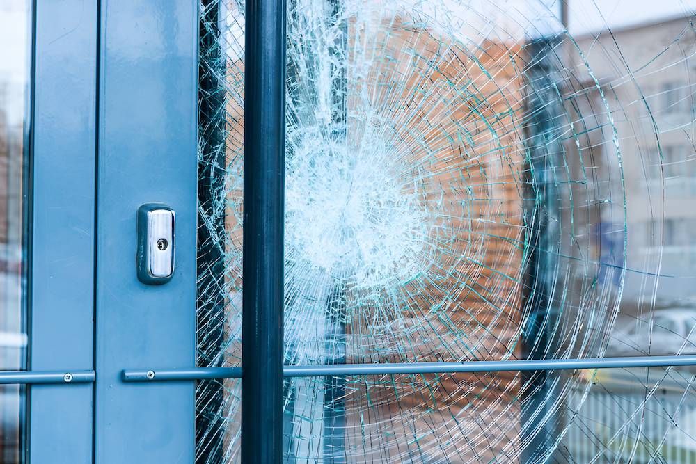 A Broken Glass Door With a Brick Wall in the Background — Luffys Glass in South Murwillumbah, NSW