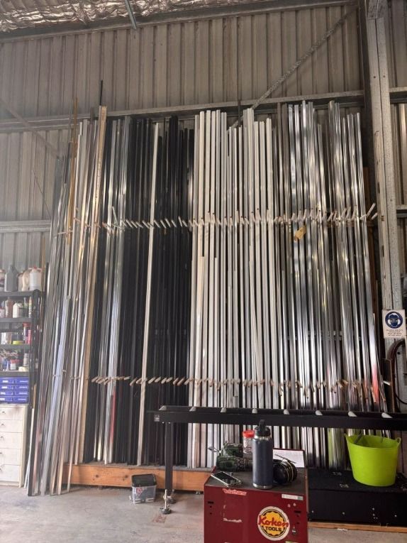 A Warehouse Filled With Lots of Metal Rods Hanging From the Ceiling — Luffys Glass in South Murwillumbah, NSW