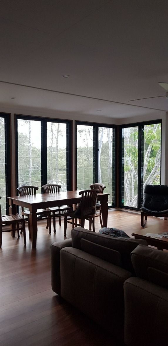 A Living Room With a Table and Chairs and a Lot of Windows — Luffys Glass in South Murwillumbah, NSW
