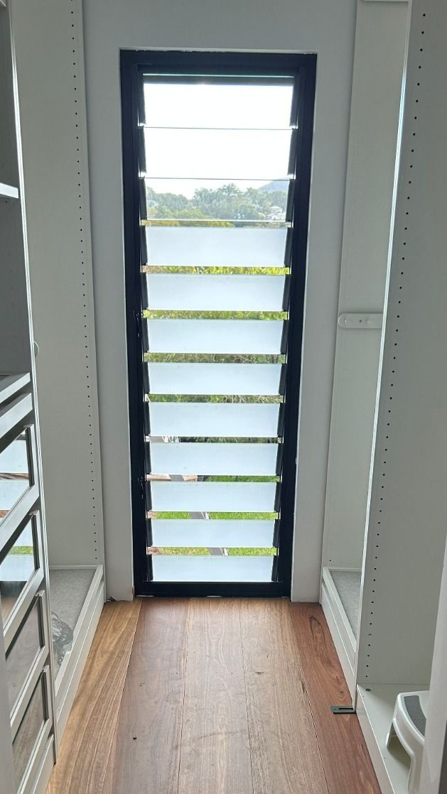 A Walk in Closet With a Large Window and a Wooden Floor — Luffys Glass in South Murwillumbah, NSW