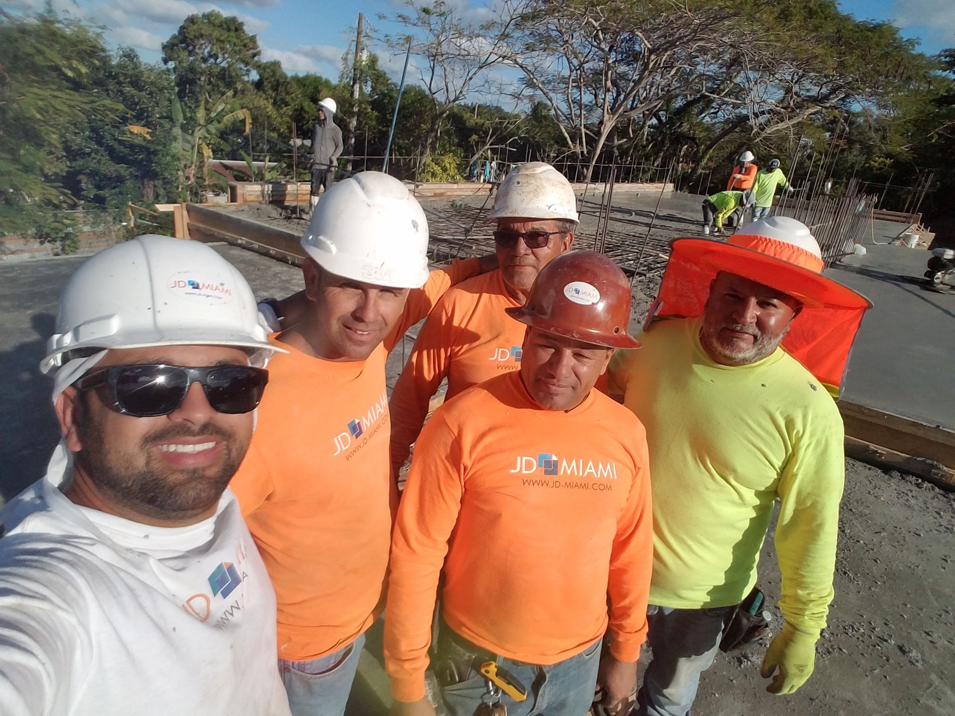 A group of construction workers are posing for a picture