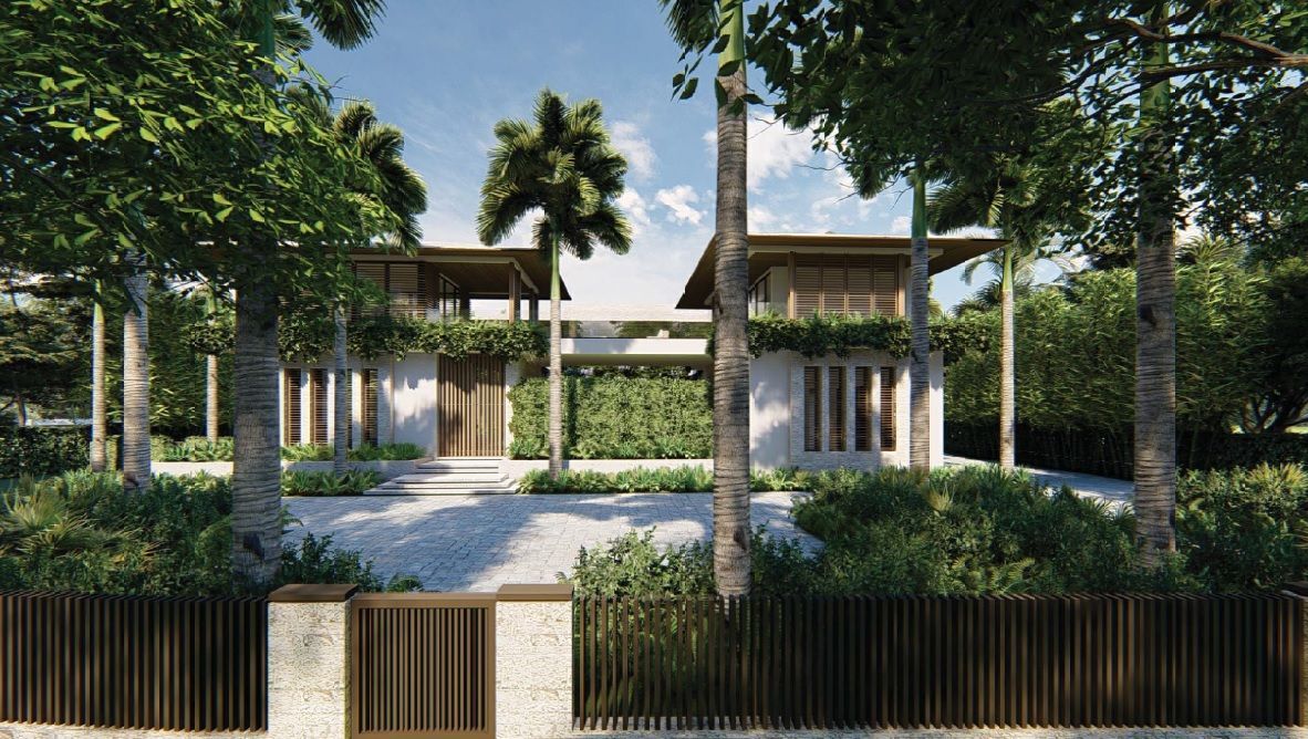 Modern home with wooden and white facade, surrounded by lush trees and a stone driveway.