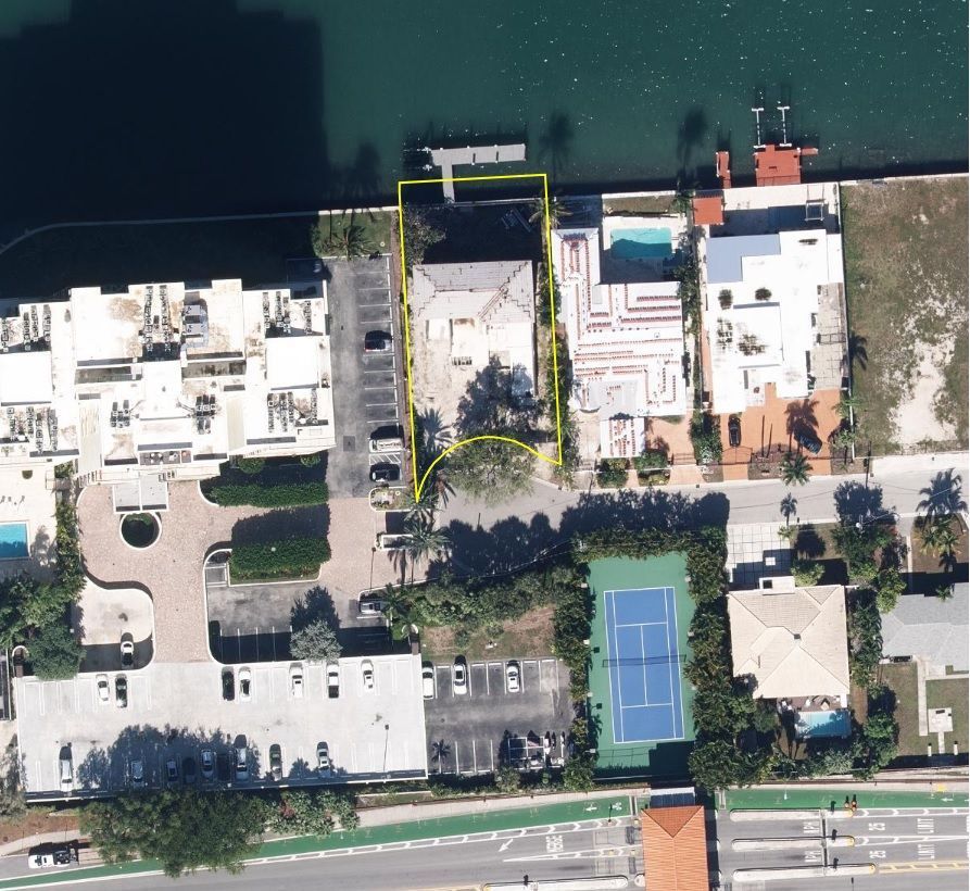 An aerial view of a residential area with a tennis court
