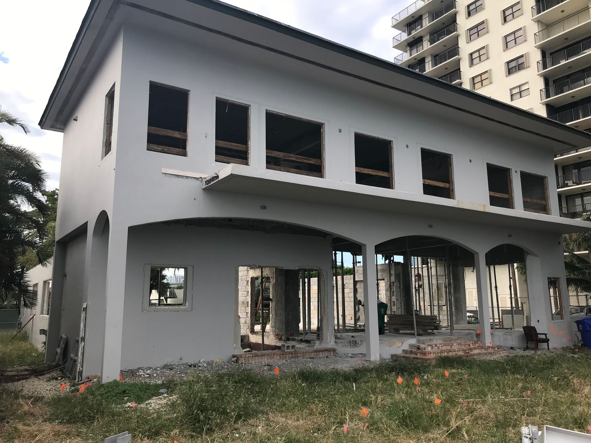 A large white building with a lot of windows is being built.
