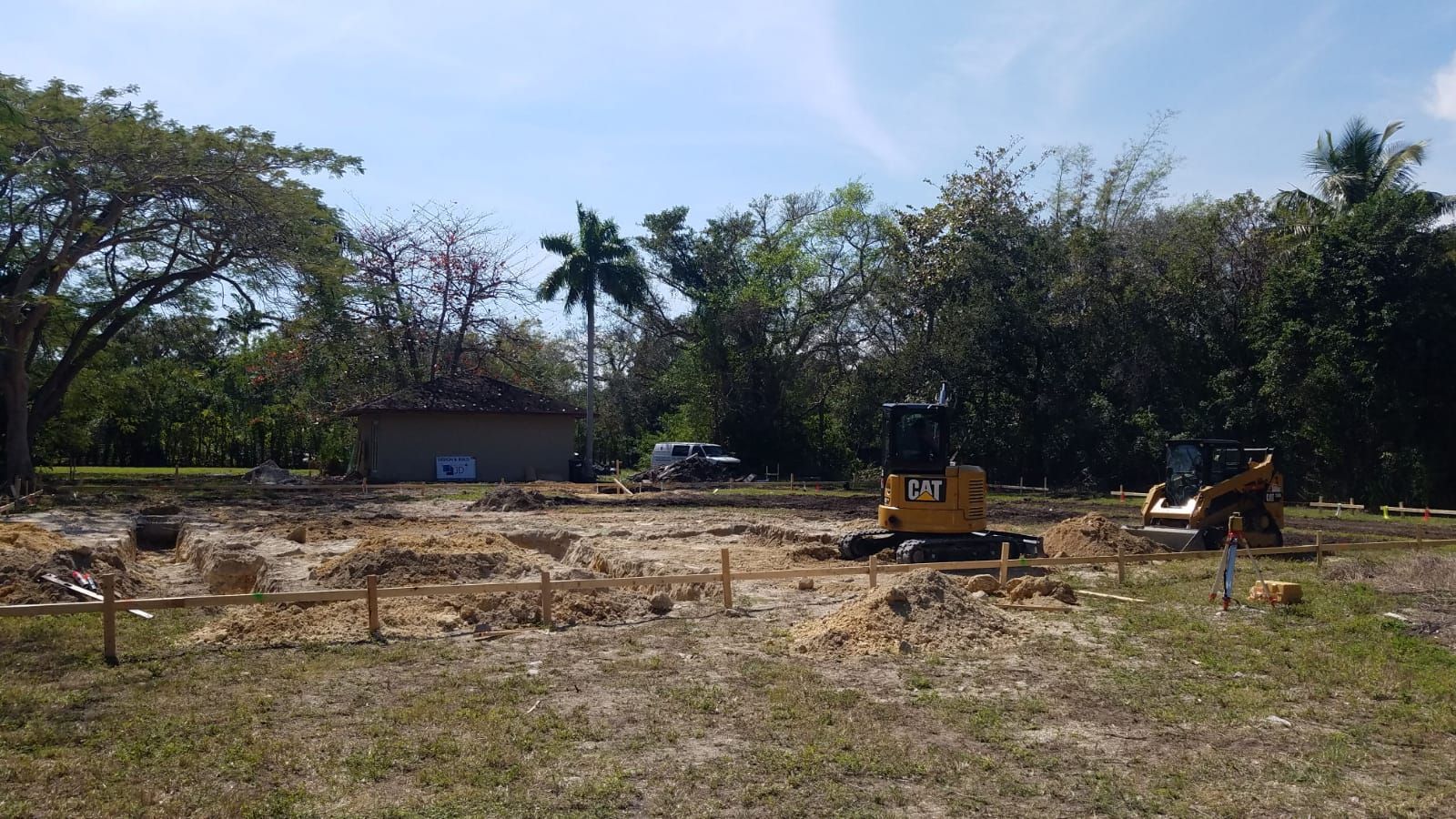 A construction site with a yellow bulldozer in the foreground