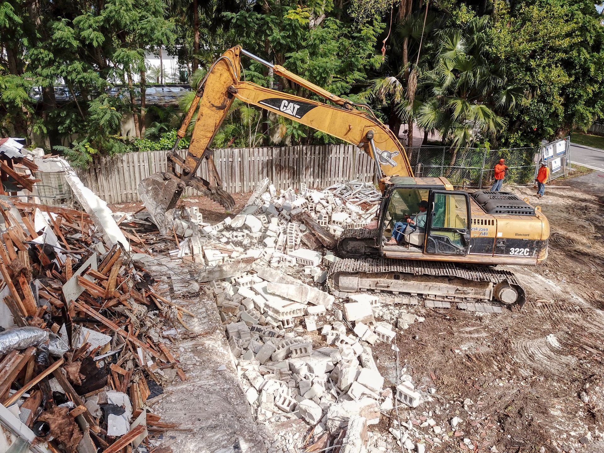 A bulldozer is moving dirt and rocks in a field.
