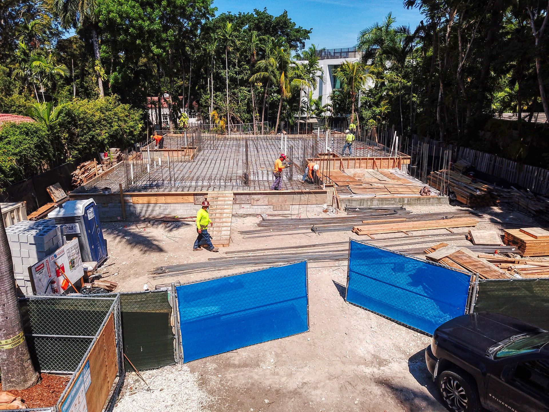 An aerial view of a construction site with a truck parked in the foreground.
