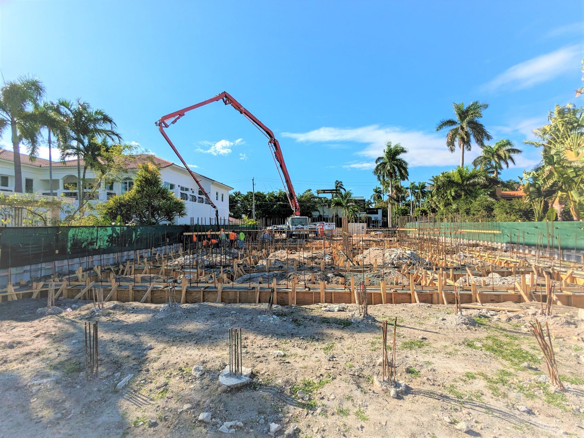 A construction site with a concrete pump in the background.