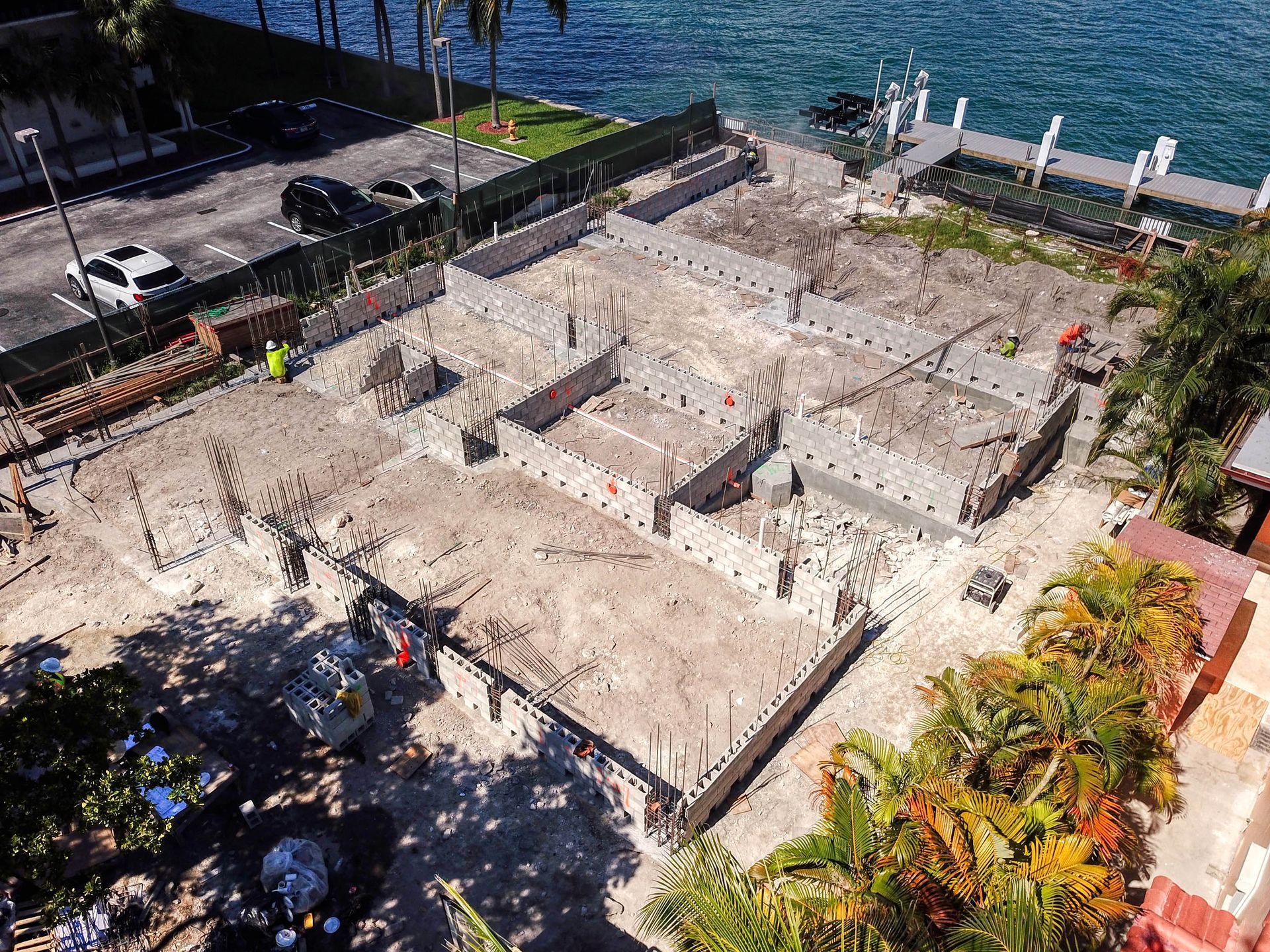 An aerial view of a construction site next to a body of water.