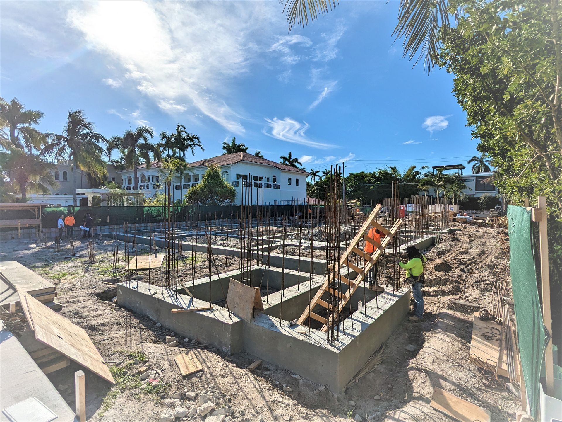 A construction site with a house in the background