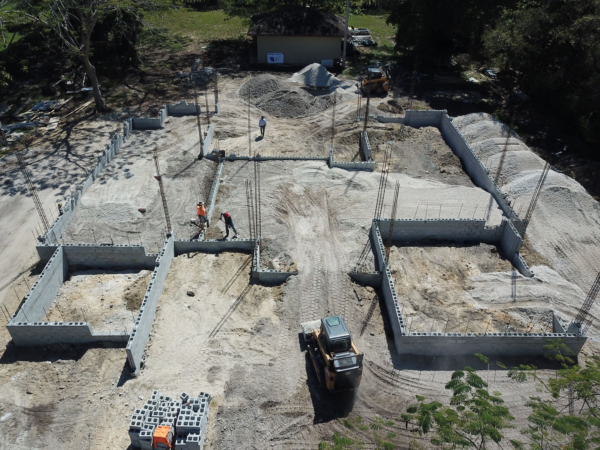 An aerial view of a construction site with a tractor in the foreground.