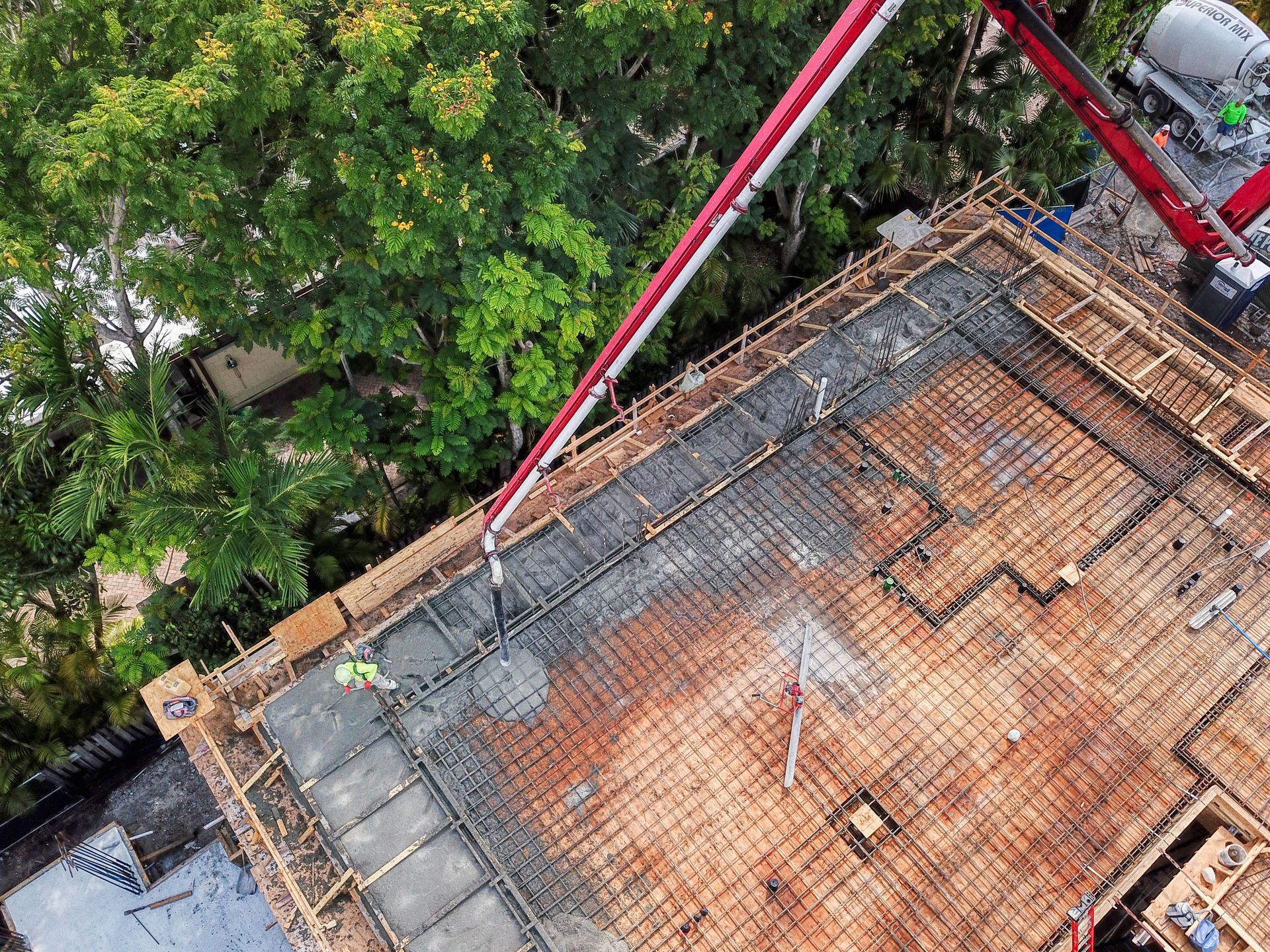 An aerial view of a construction site with a concrete pump.