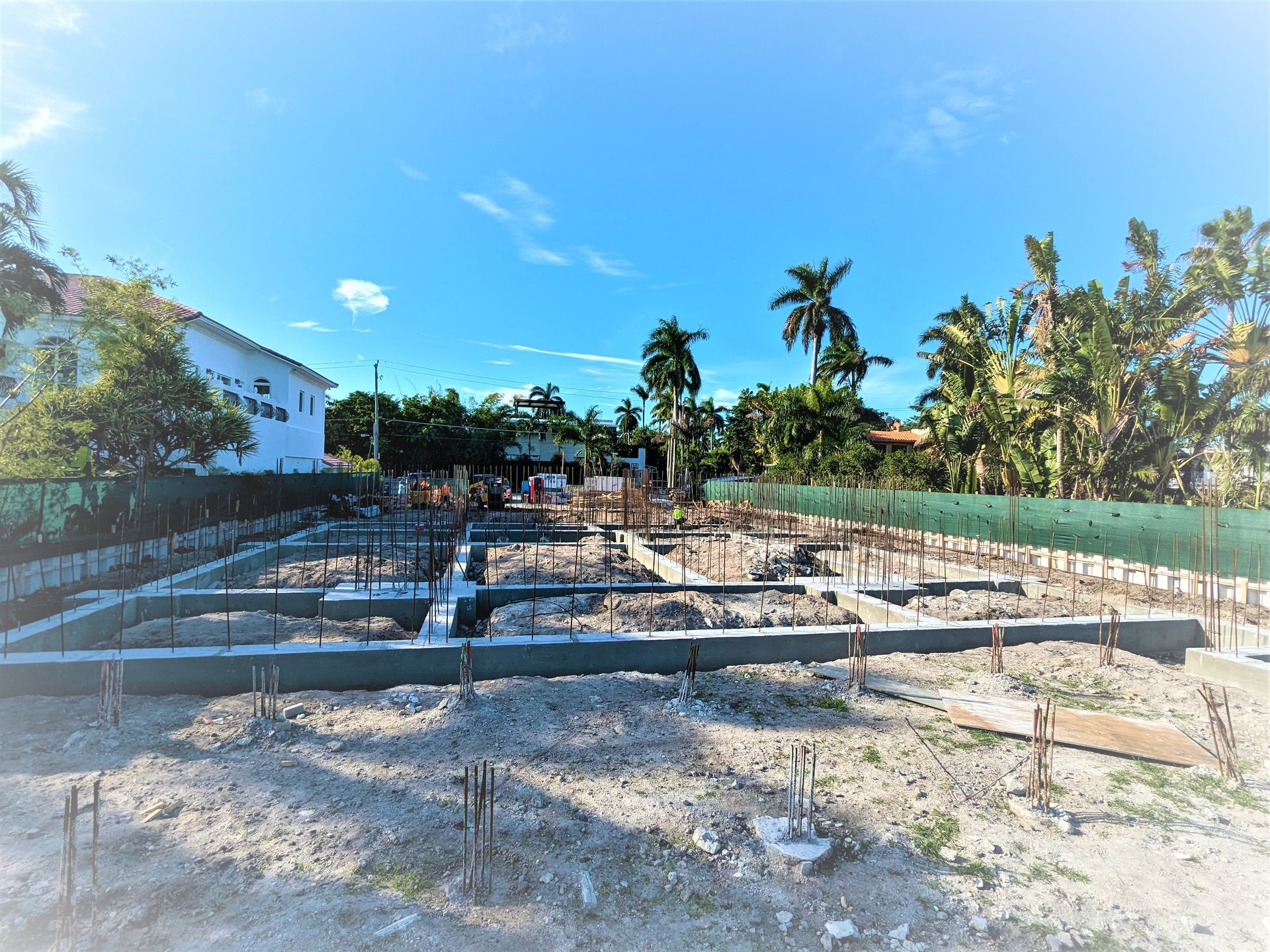 A construction site with a lot of dirt and trees in the background