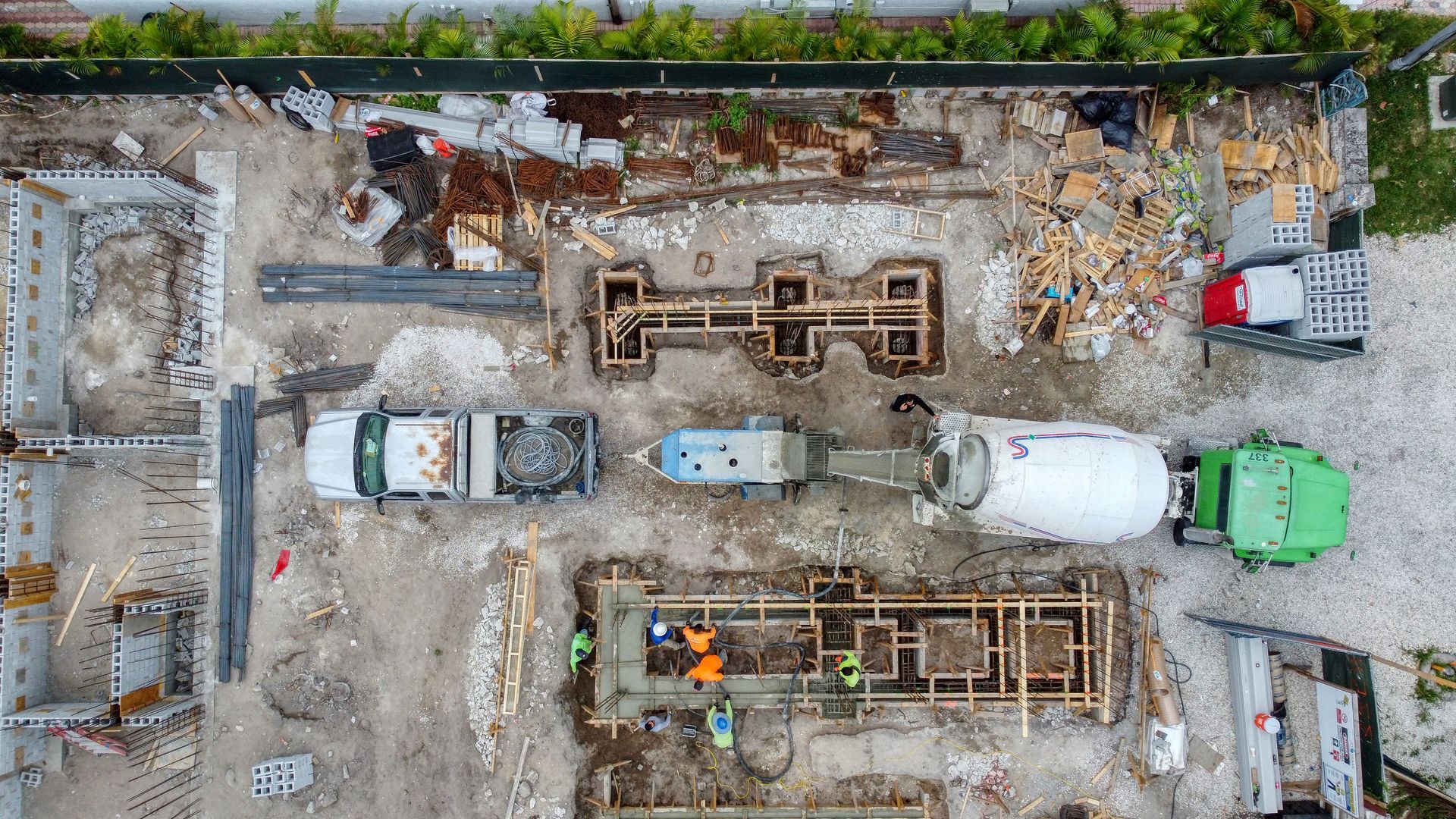 An aerial view of a construction site with trucks and workers.