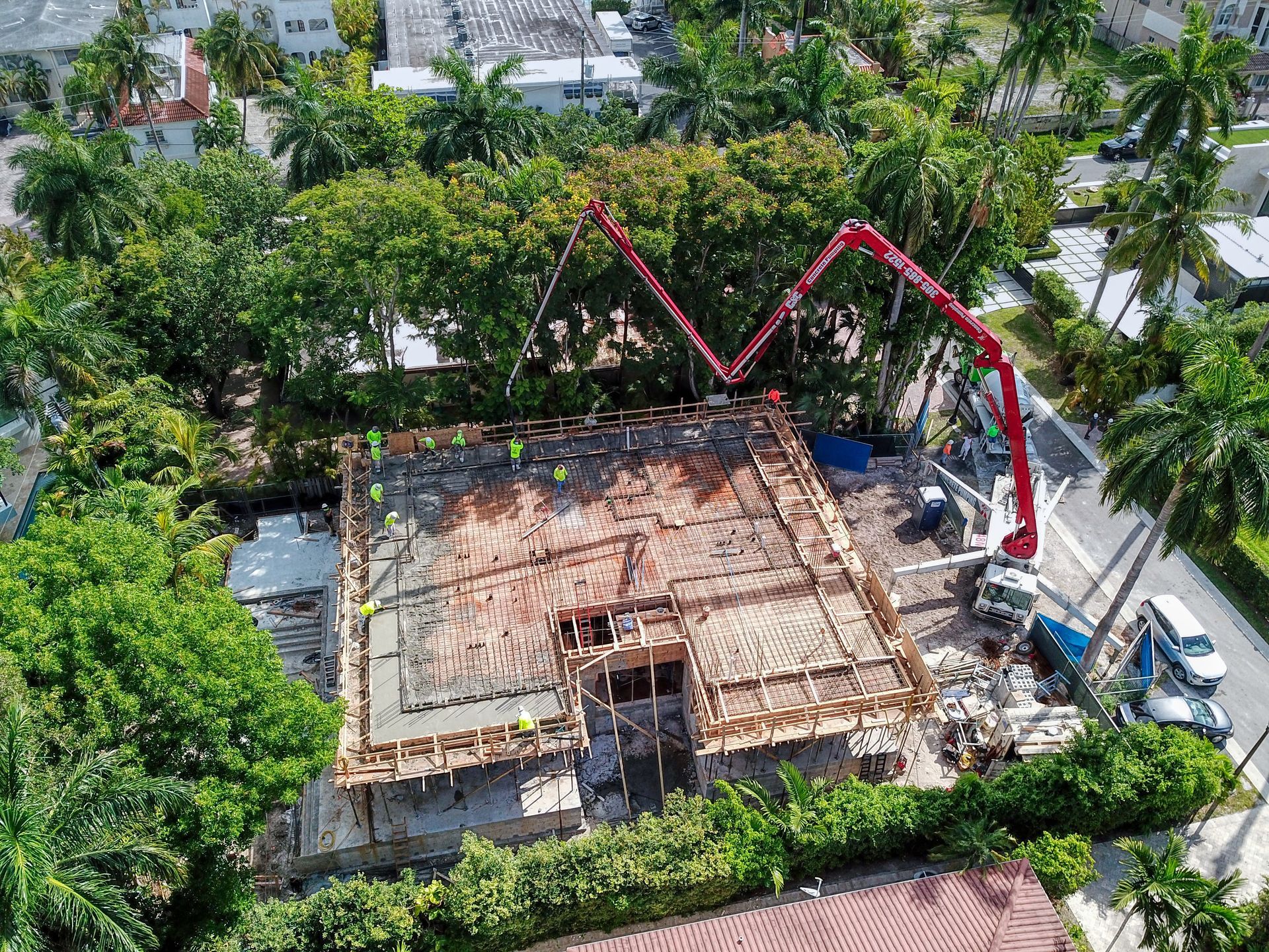 An aerial view of a building under construction with a concrete pump.