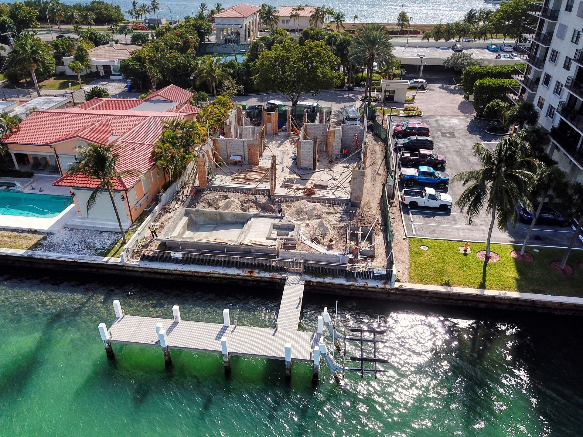 An aerial view of a building under construction next to a body of water.