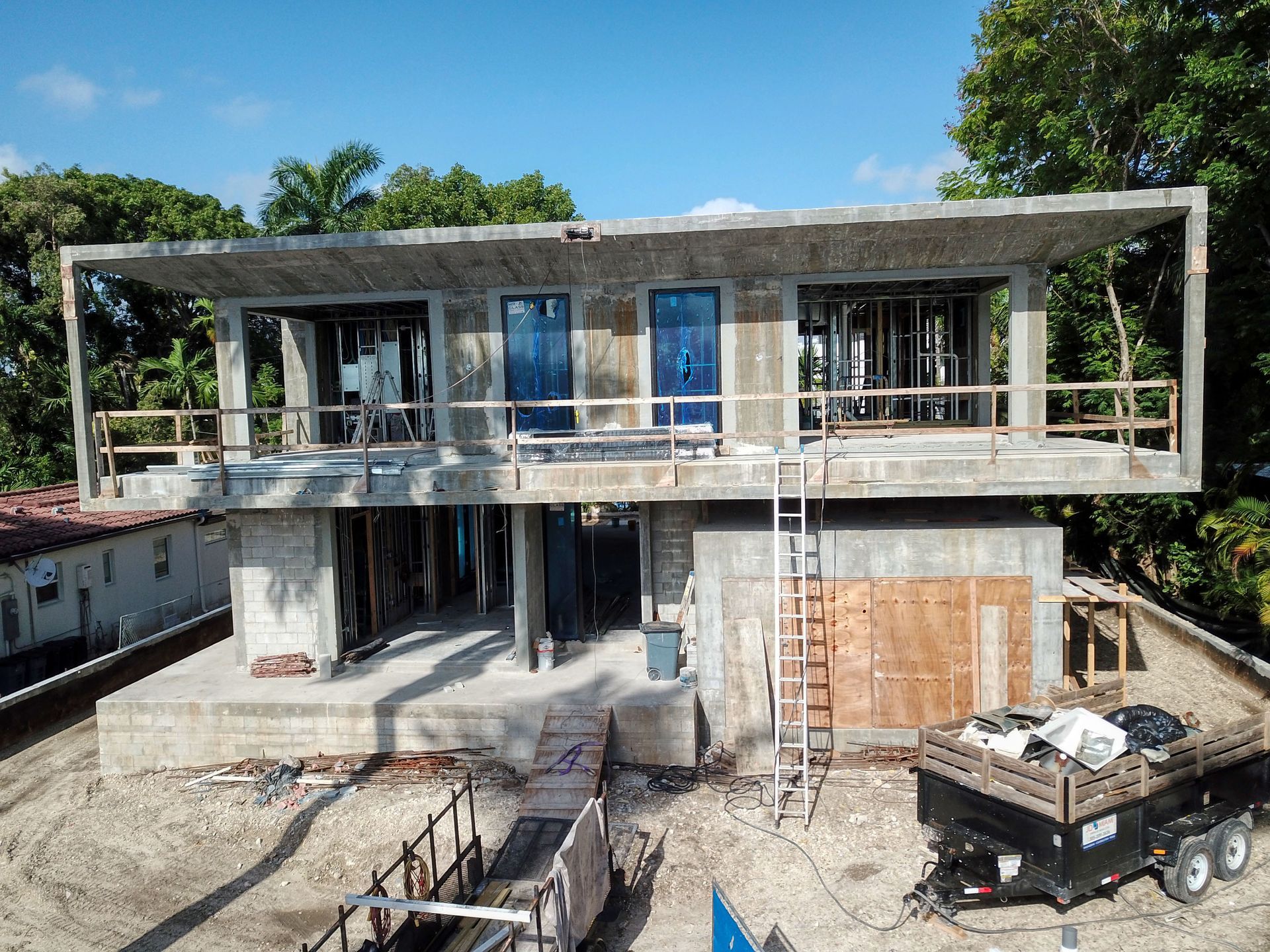 An aerial view of a house under construction with a trailer parked in front of it.