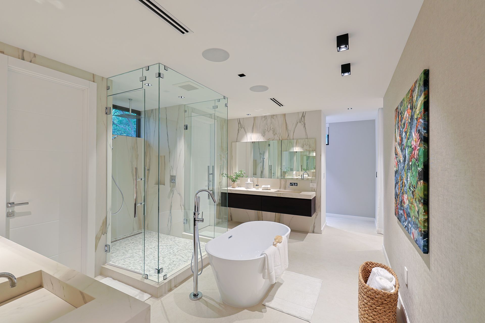Luxurious white bathroom with a glass shower, soaking tub, and double vanity.