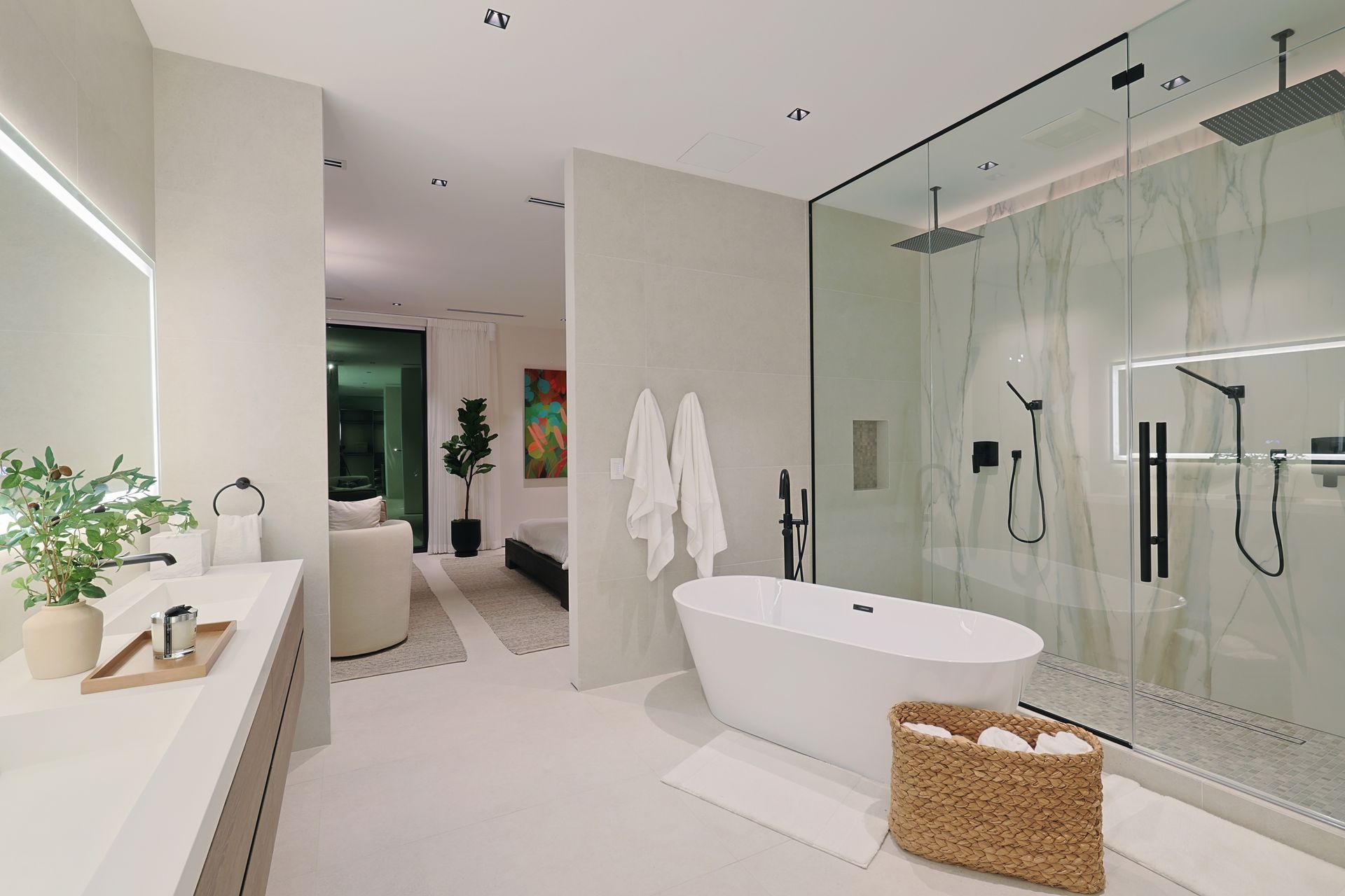 Modern bathroom with white tub, walk-in shower, and vanity; soft lighting and neutral tones.