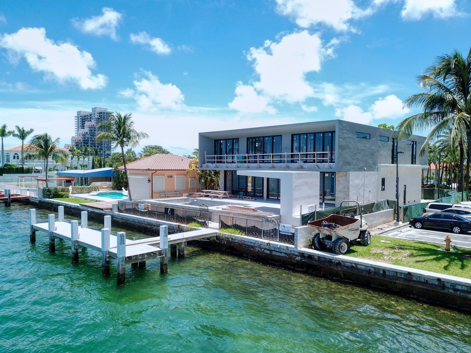 An aerial view of a large house next to a body of water.