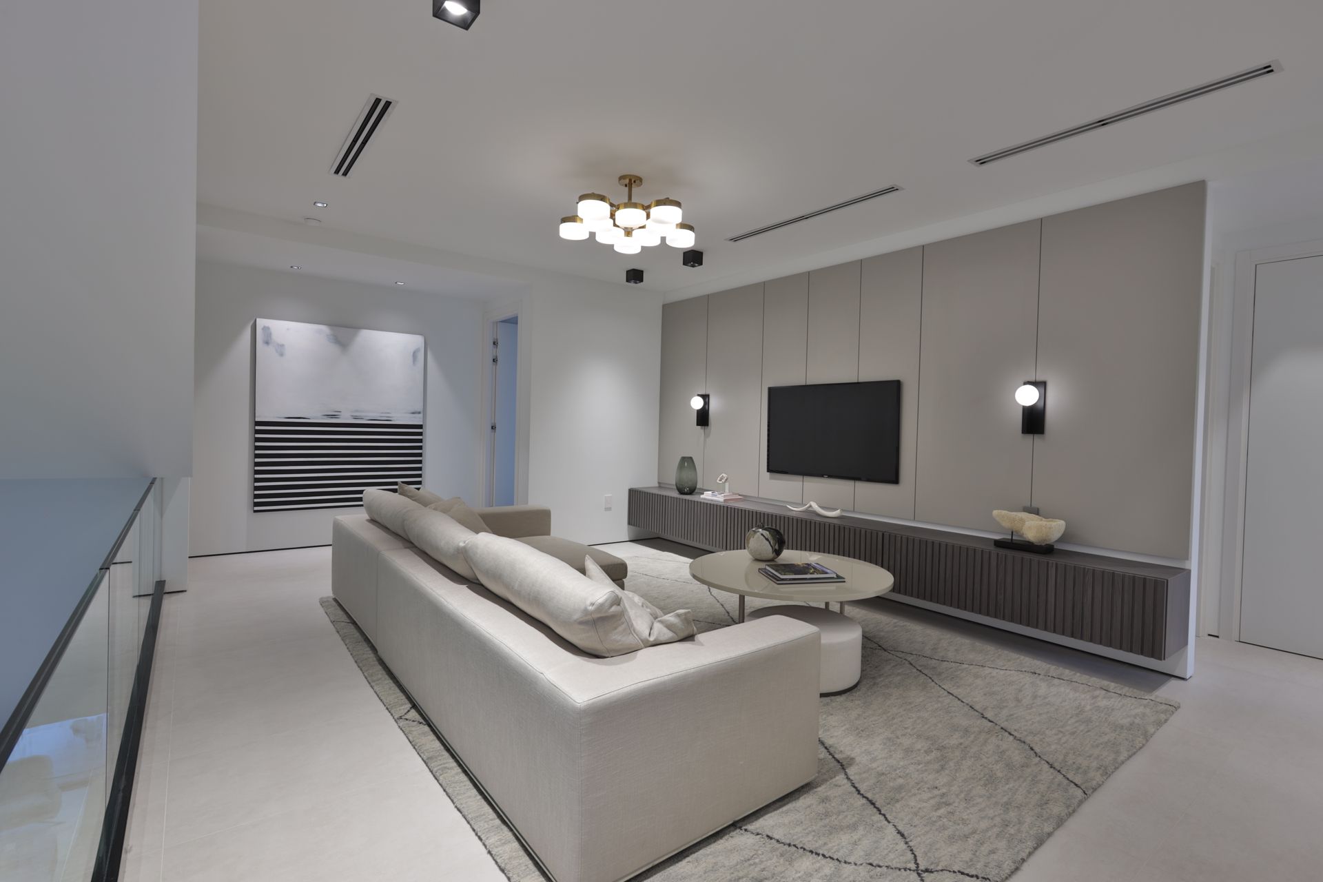 A living room with a white couch and a flat screen tv