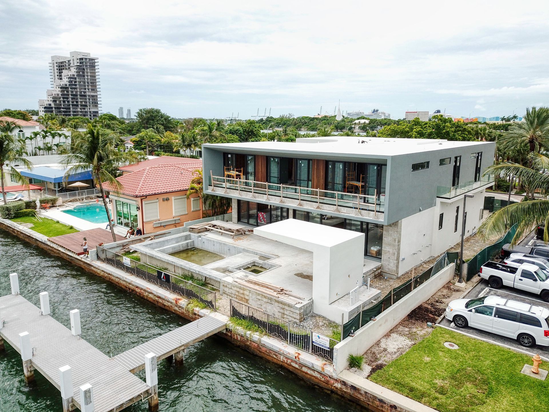 An aerial view of a large house next to a body of water.