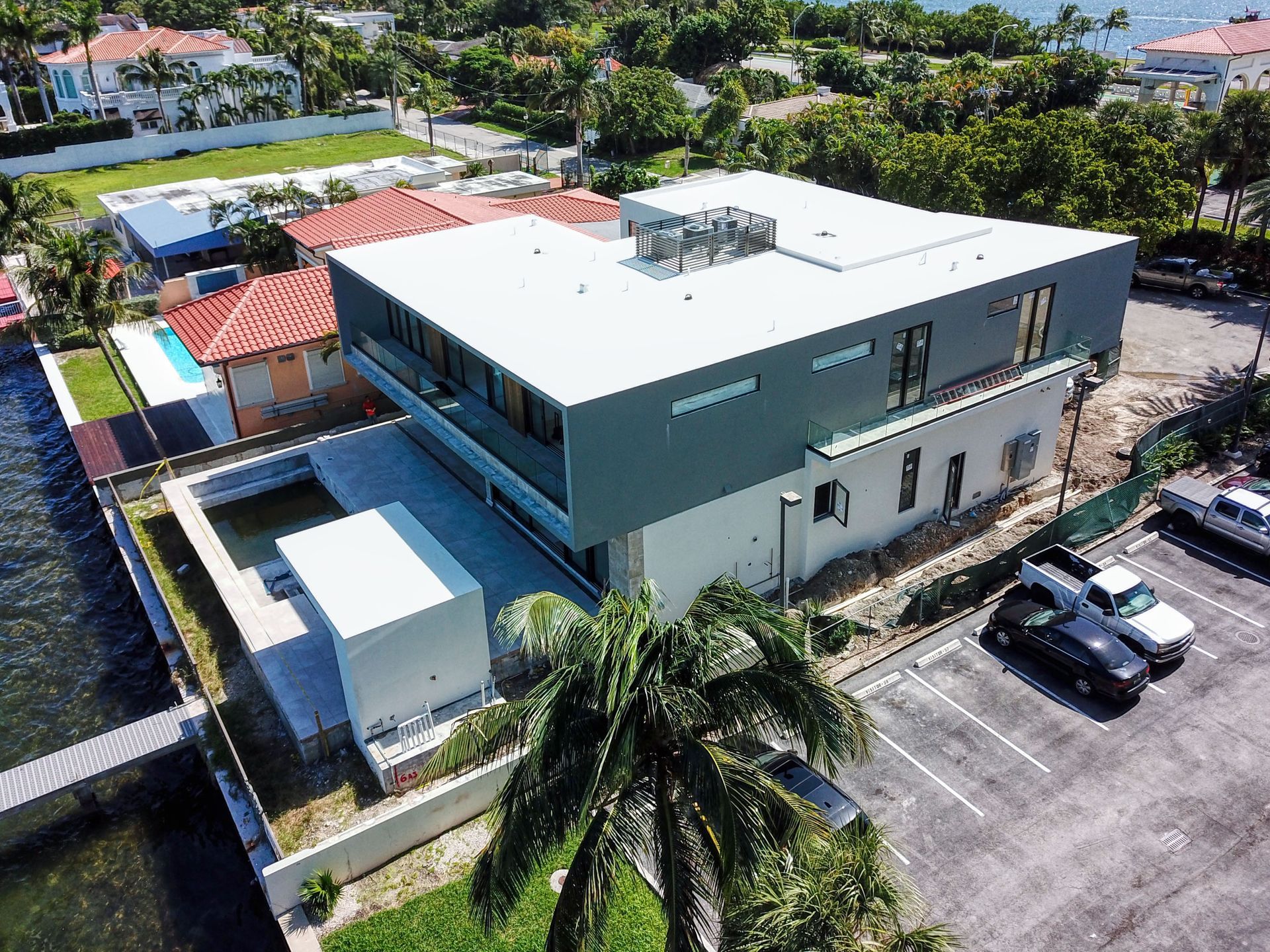 An aerial view of a large building next to a parking lot